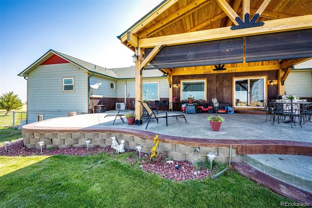 rear view of house with ceiling fan and a patio