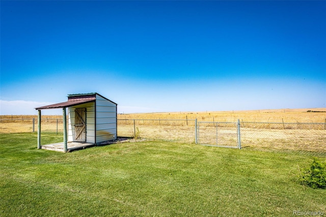 view of yard with a rural view and a storage unit