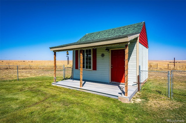 view of outbuilding featuring a yard and a rural view