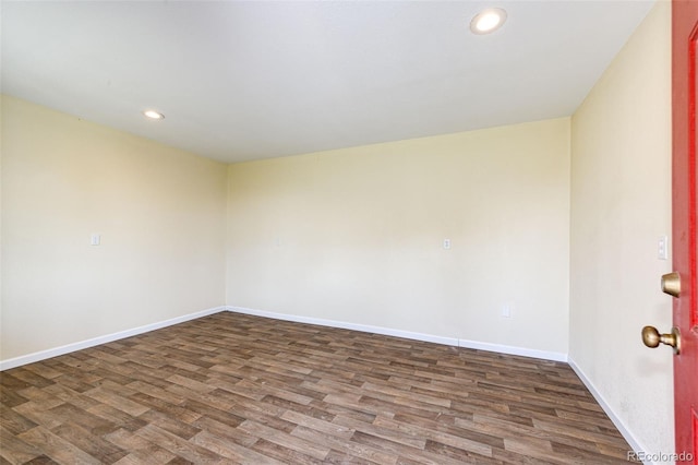 spare room with dark wood-type flooring