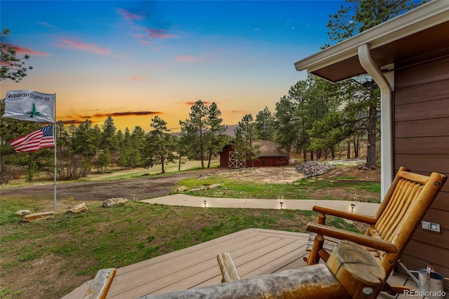 view of yard featuring an outdoor structure and a deck
