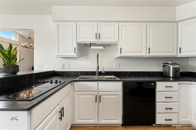kitchen featuring a sink, white cabinetry, black appliances, and dark countertops