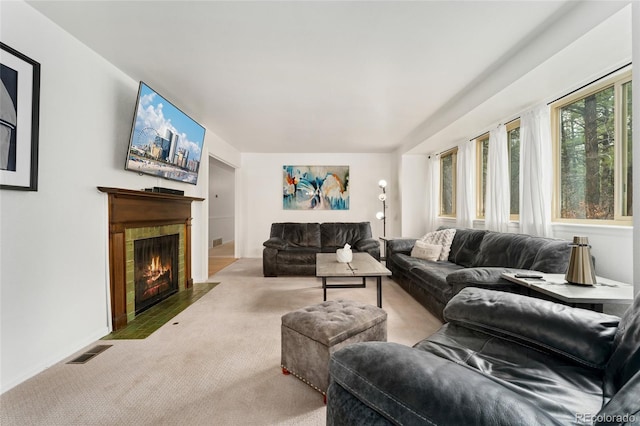 living room with baseboards, a fireplace, carpet flooring, and visible vents