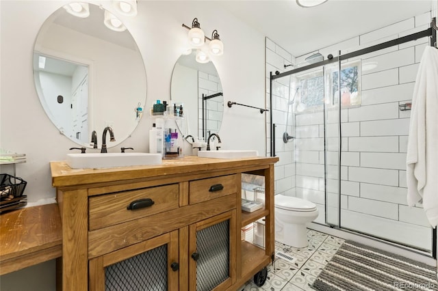full bath featuring a sink, a shower stall, and toilet