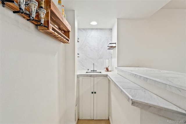 bathroom with a sink, walk in shower, and recessed lighting