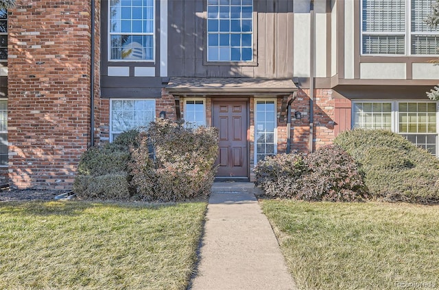 doorway to property with a yard