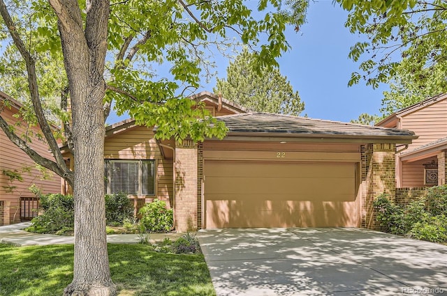 7500 E Dartmouth Ave Unit 22, Denver, CO 80231 - view of front of house featuring brick siding, a garage, and driveway