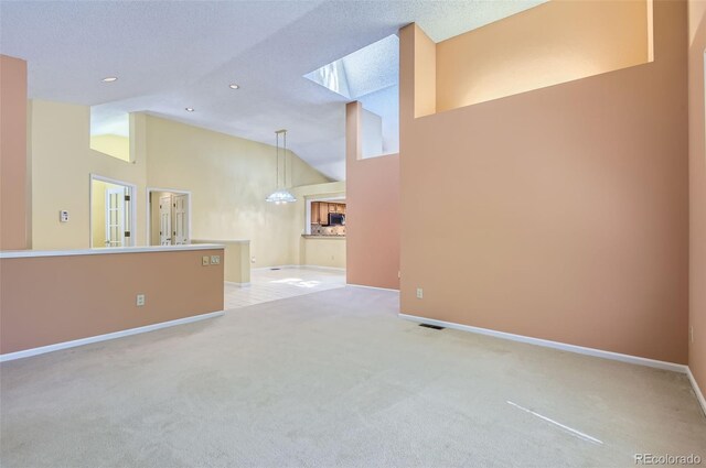 7500 E Dartmouth Ave Unit 22, Denver, CO 80231 - unfurnished living room with light carpet, high vaulted ceiling, baseboards, and recessed lighting
