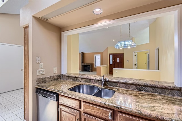 7500 E Dartmouth Ave Unit 22, Denver, CO 80231 - kitchen featuring stainless steel dishwasher, a sink, light tile patterned floors, stone countertops, and decorative light fixtures