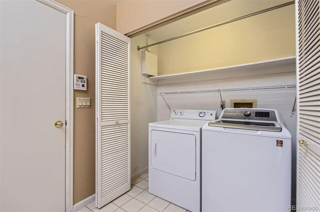 7500 E Dartmouth Ave Unit 22, Denver, CO 80231 - laundry area featuring washer and clothes dryer and light tile patterned floors