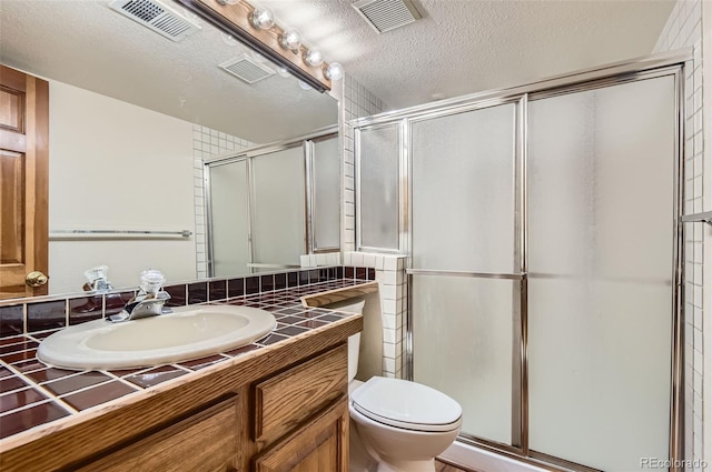7500 E Dartmouth Ave Unit 22, Denver, CO 80231 - bathroom featuring vanity, a shower stall, toilet, and a textured ceiling