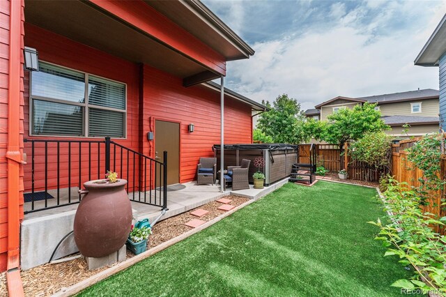 2868 Kingston St, Denver, CO 80238 - fenced backyard featuring a hot tub and a patio