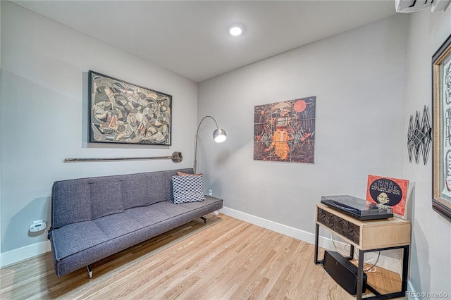 114 Old Stage Rd Unit D, Salida, CO 81201 - living area with wood finished floors, baseboards, and an AC wall unit
