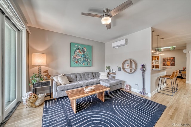 114 Old Stage Rd Unit D, Salida, CO 81201 - living room featuring ceiling fan, a wall mounted AC, wood finished floors, and healthy amount of natural light