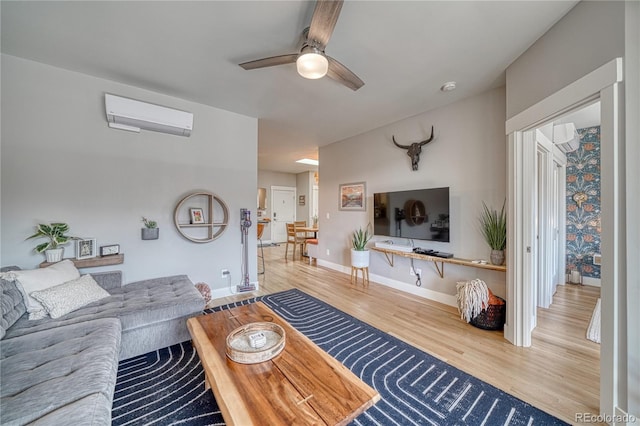 114 Old Stage Rd Unit D, Salida, CO 81201 - living area with an AC wall unit, wood finished floors, a ceiling fan, and baseboards