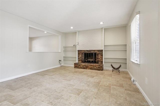 2518 S Dawson Way, Aurora, CO 80014 - unfurnished living room featuring a fireplace, built in shelves, and recessed lighting