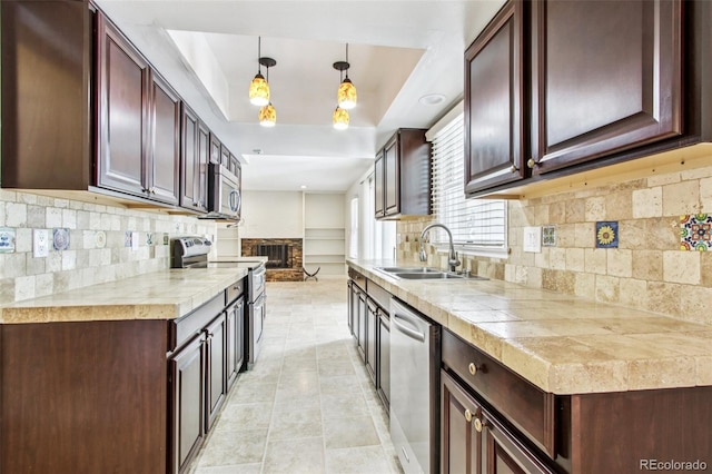 2518 S Dawson Way, Aurora, CO 80014 - kitchen featuring appliances with stainless steel finishes, decorative backsplash, a tray ceiling, light tile patterned flooring, and light countertops