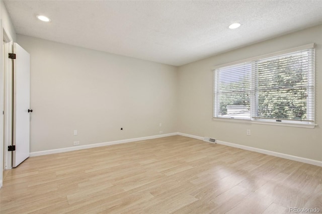 2518 S Dawson Way, Aurora, CO 80014 - spare room featuring light wood-style flooring, recessed lighting, and a textured ceiling