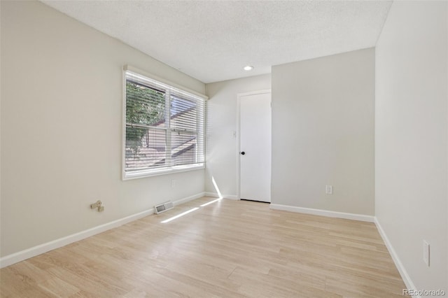2518 S Dawson Way, Aurora, CO 80014 - empty room featuring light wood-style flooring and a textured ceiling