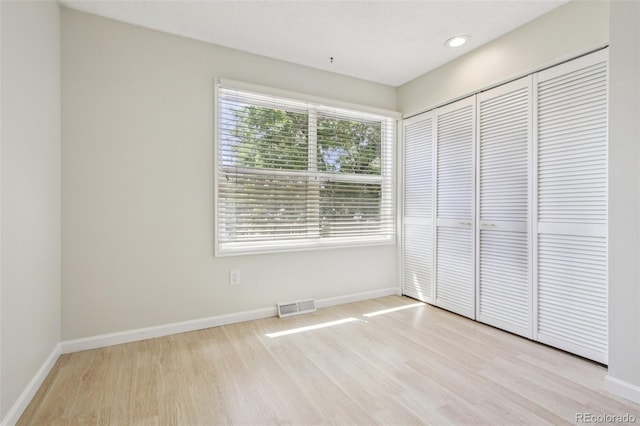 2518 S Dawson Way, Aurora, CO 80014 - unfurnished bedroom with wood finished floors, a closet, and recessed lighting
