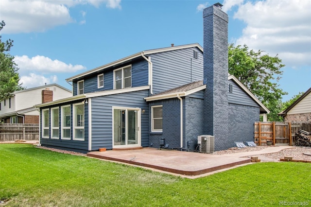 2518 S Dawson Way, Aurora, CO 80014 - back of house with a chimney, a patio, a fenced backyard, and brick siding