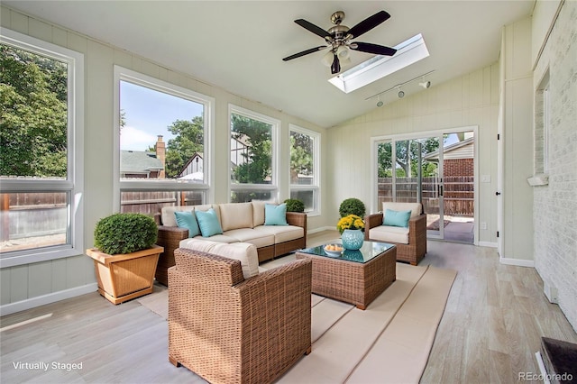 2518 S Dawson Way, Aurora, CO 80014 - sunroom featuring a skylight, wood finished floors, and vaulted ceiling