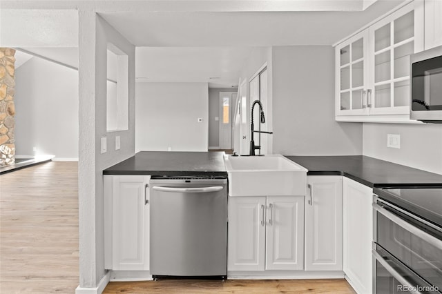 13633 E Yale Ave Unit B, Aurora, CO 80015 - kitchen featuring appliances with stainless steel finishes, a sink, dark countertops, and white cabinets