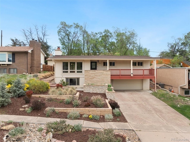 813 Panorama Dr, Colorado Springs, CO 80904 - view of front facade with stucco siding, a garage, concrete driveway, and a chimney