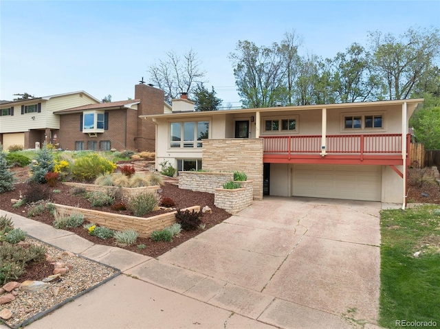 813 Panorama Dr, Colorado Springs, CO 80904 - view of front of house featuring an attached garage, driveway, a chimney, stucco siding, and stone siding