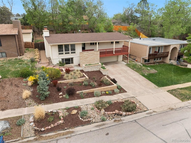 813 Panorama Dr, Colorado Springs, CO 80904 - view of front of home featuring concrete driveway, a chimney, a garage, and stucco siding