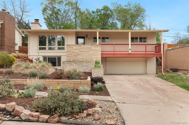 813 Panorama Dr, Colorado Springs, CO 80904 - view of front of home featuring stucco siding, a garage, stone siding, and driveway