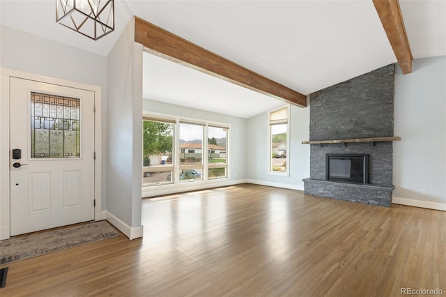 813 Panorama Dr, Colorado Springs, CO 80904 - unfurnished living room with wood finished floors, baseboards, and a stone fireplace