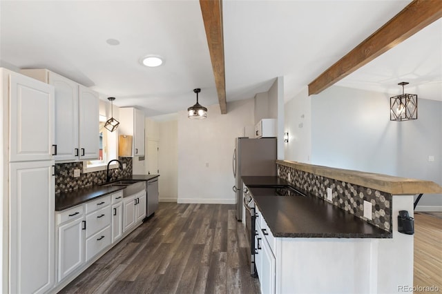 813 Panorama Dr, Colorado Springs, CO 80904 - kitchen with dark countertops, appliances with stainless steel finishes, a sink, beam ceiling, and backsplash