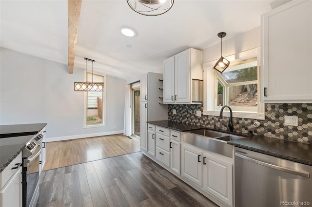 813 Panorama Dr, Colorado Springs, CO 80904 - kitchen with stainless steel dishwasher, a sink, dark countertops, and decorative backsplash