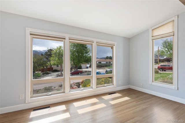 813 Panorama Dr, Colorado Springs, CO 80904 - unfurnished room with wood finished floors, plenty of natural light, and baseboards