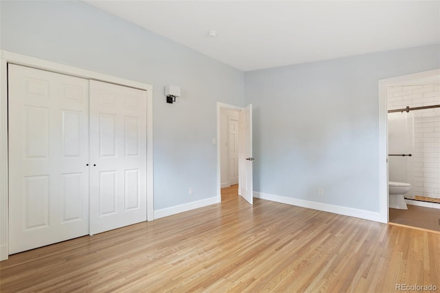 813 Panorama Dr, Colorado Springs, CO 80904 - unfurnished bedroom featuring light wood-style floors, a closet, baseboards, and ensuite bath