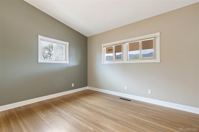 813 Panorama Dr, Colorado Springs, CO 80904 - unfurnished room with baseboards, lofted ceiling, and light wood-style flooring