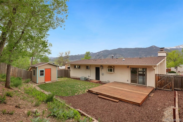 813 Panorama Dr, Colorado Springs, CO 80904 - rear view of property featuring cooling unit, a deck with mountain view, a chimney, and stucco siding