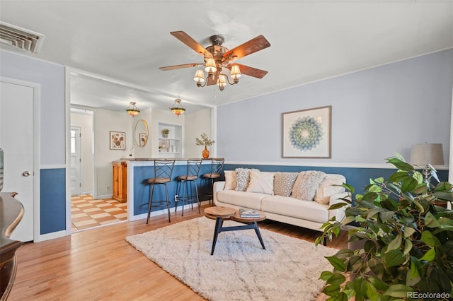 living room featuring ceiling fan and light wood-type flooring