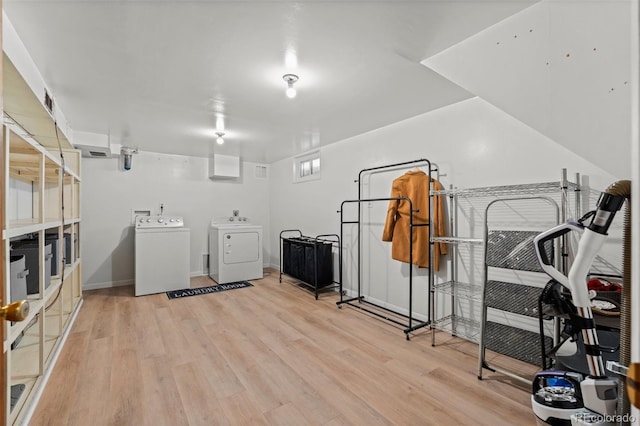 washroom featuring light wood-type flooring and washer and clothes dryer