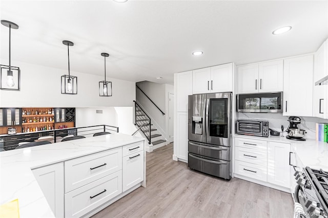 7302 E Bates Dr, Denver, CO 80231 - kitchen featuring stainless steel appliances, light stone countertops, hanging light fixtures, white cabinets, and recessed lighting