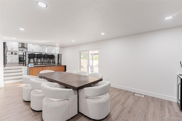 7302 E Bates Dr, Denver, CO 80231 - dining area featuring light wood-style flooring and recessed lighting