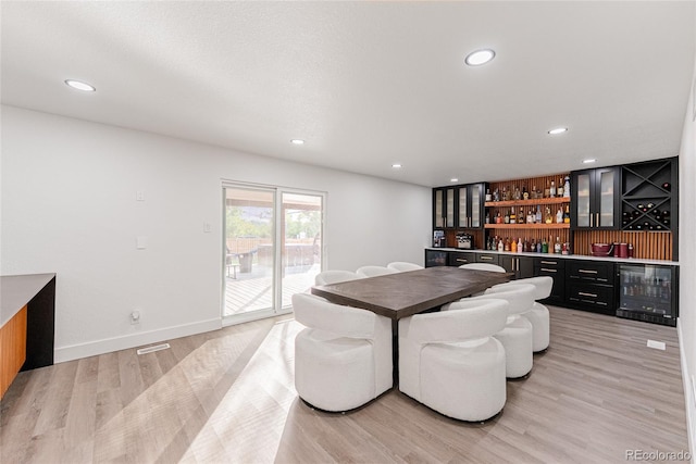 7302 E Bates Dr, Denver, CO 80231 - dining room with wine cooler, a dry bar, light wood finished floors, and recessed lighting