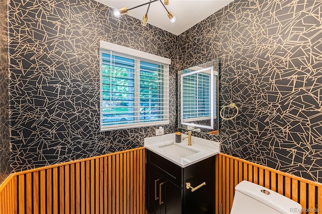 7302 E Bates Dr, Denver, CO 80231 - half bathroom featuring wallpapered walls and vanity
