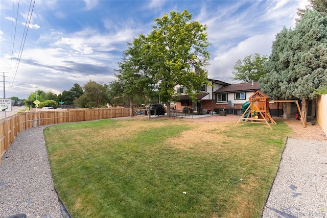 7302 E Bates Dr, Denver, CO 80231 - fenced backyard featuring a playground and a patio