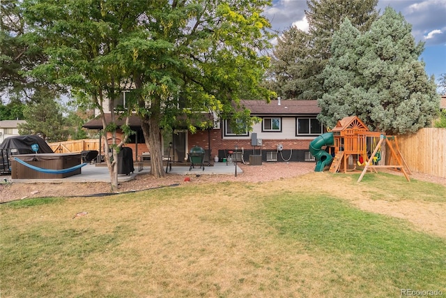 7302 E Bates Dr, Denver, CO 80231 - fenced backyard with a patio area, a hot tub, and a playground