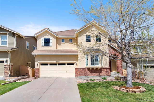 10633 Wynspire Way, Highlands Ranch, CO 80130 - traditional home with stucco siding, brick siding, an attached garage, and driveway