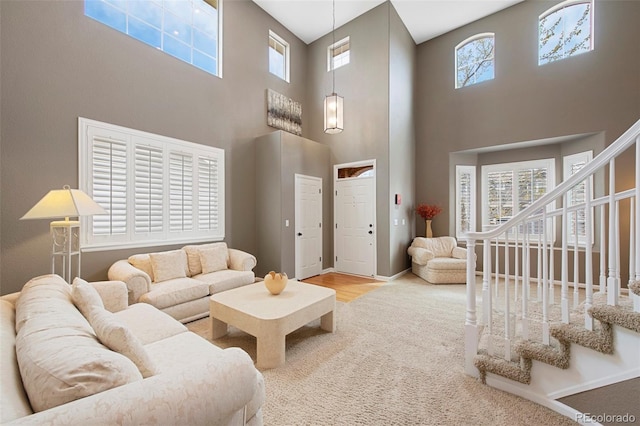 10633 Wynspire Way, Highlands Ranch, CO 80130 - carpeted living room with a towering ceiling and stairway