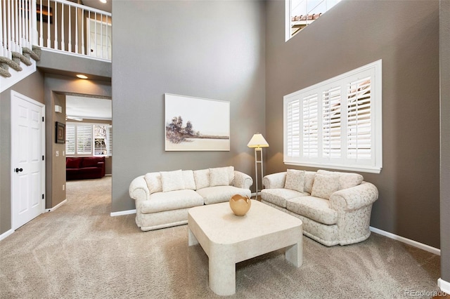 10633 Wynspire Way, Highlands Ranch, CO 80130 - carpeted living area featuring a towering ceiling and baseboards