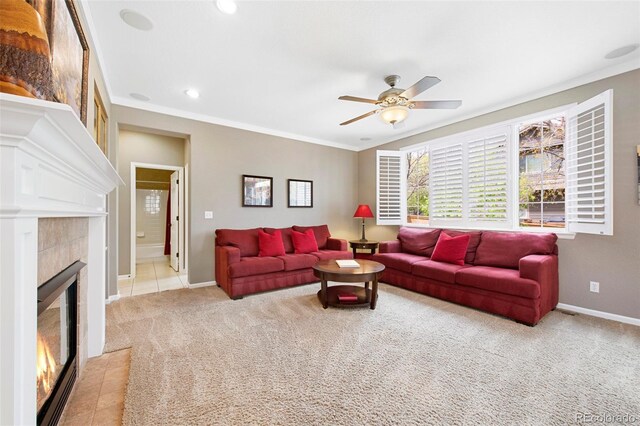 10633 Wynspire Way, Highlands Ranch, CO 80130 - tiled living area with ceiling fan, a tiled fireplace, carpet, crown molding, and recessed lighting